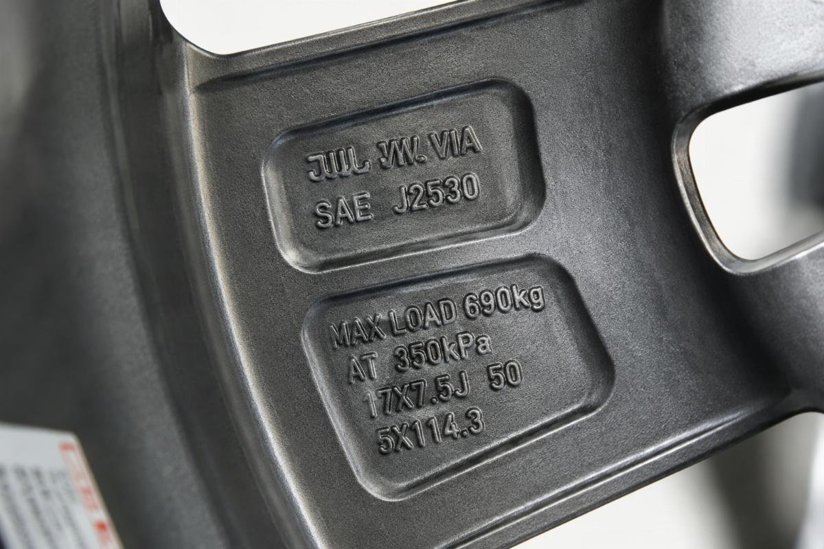 Alloy wheel certification and load rating close-up shot
